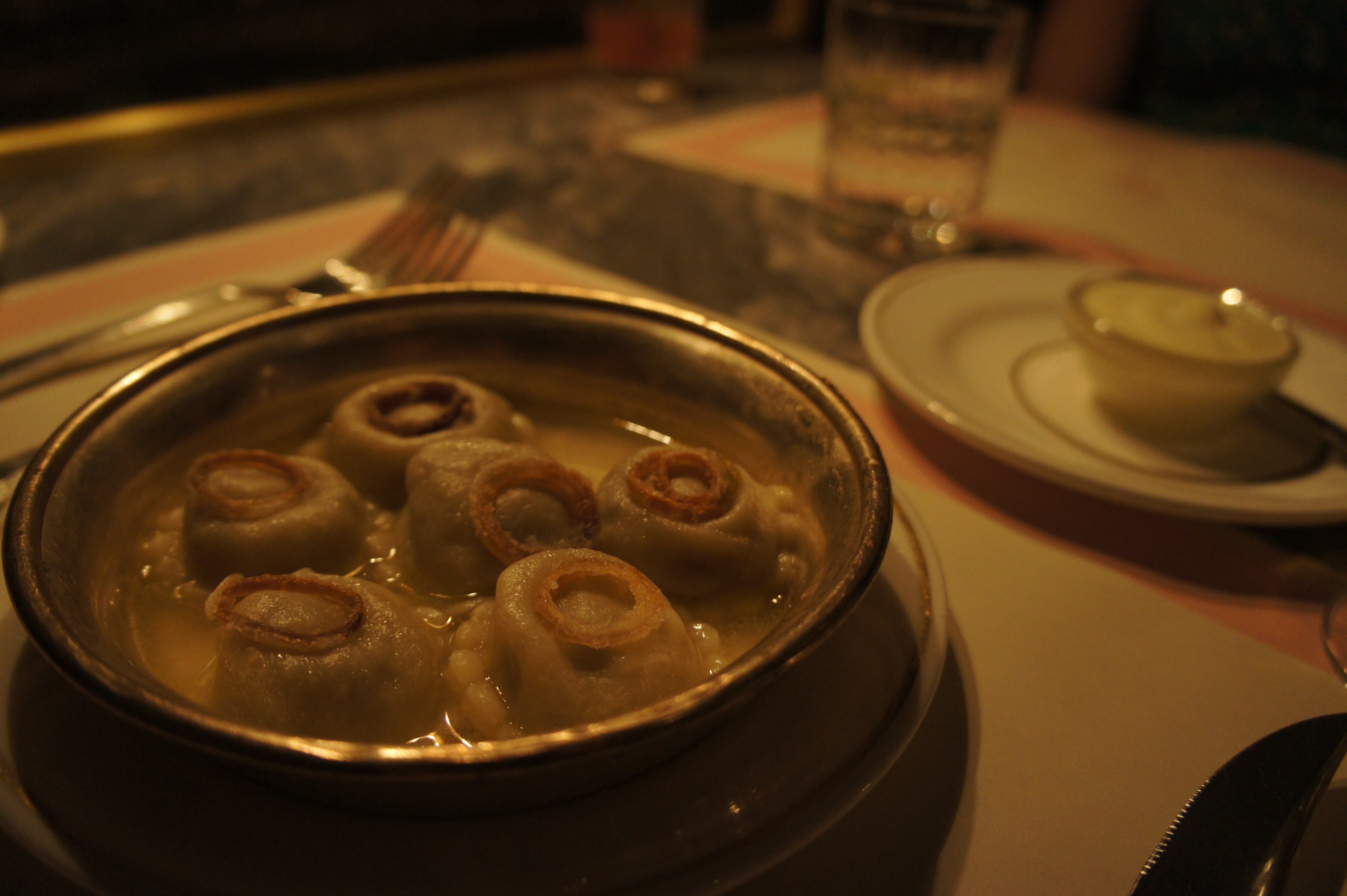 Truffled Potato and Porcini Vareniki served with Crispy Onion Rings and Sour Cream